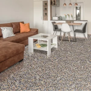 Sol en terrazzo PP09 Carodeco avec éclats de marbre multicolores sur fond sombre, dans un salon contemporain