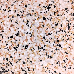 Carrelage terrazzo Carodeco finition beige avec éclats noirs et tons chauds